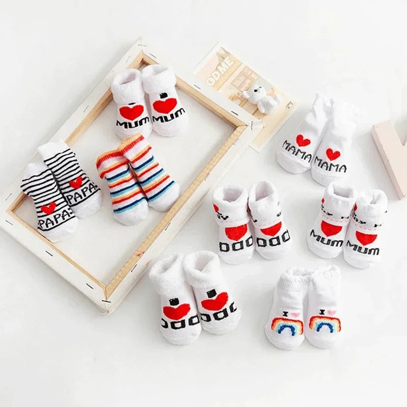 Set of baby socks with 'Mum' and 'Papa' text on a white background