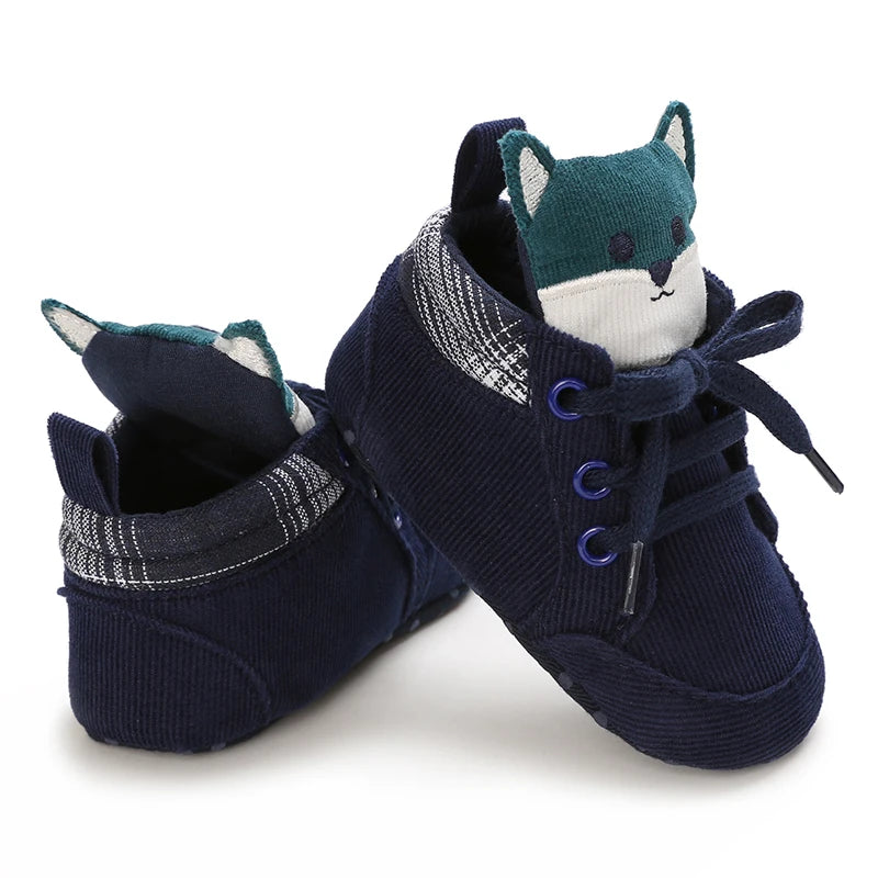 Navy blue baby shoes with fox design on a white background