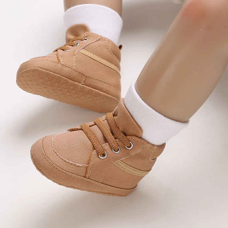 Brown baby shoes with white socks on a light background