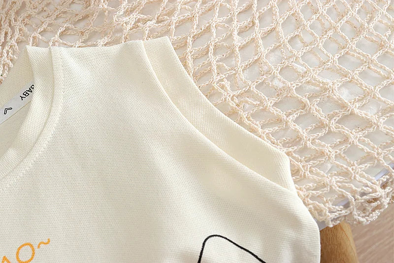 White sleeveless top with text on a textured beige background