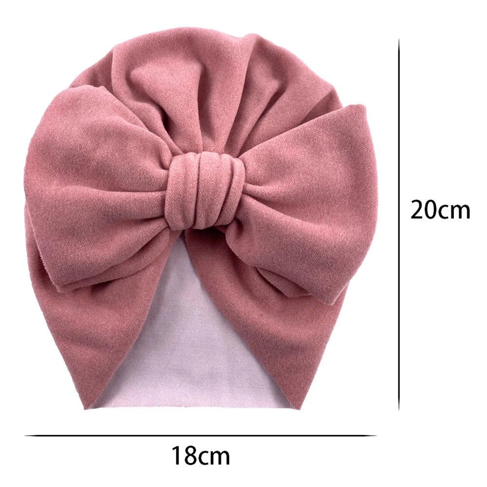 Pink headscarf with a large bow and measurements on a white background