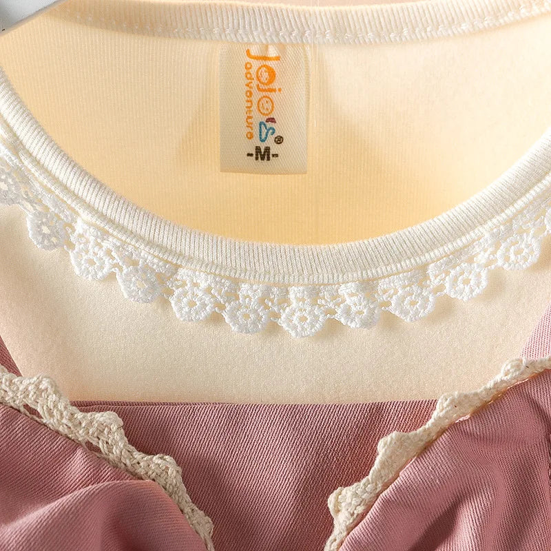 Close-up of a garment with lace details and a brand label.