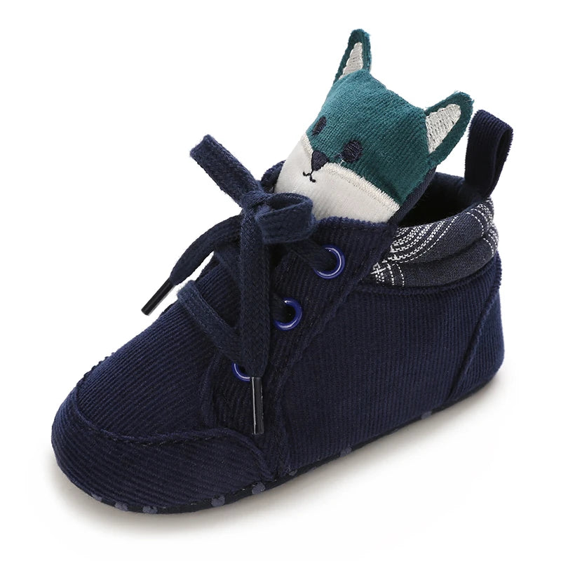 Navy blue baby shoe with a fox toy inside on a white background