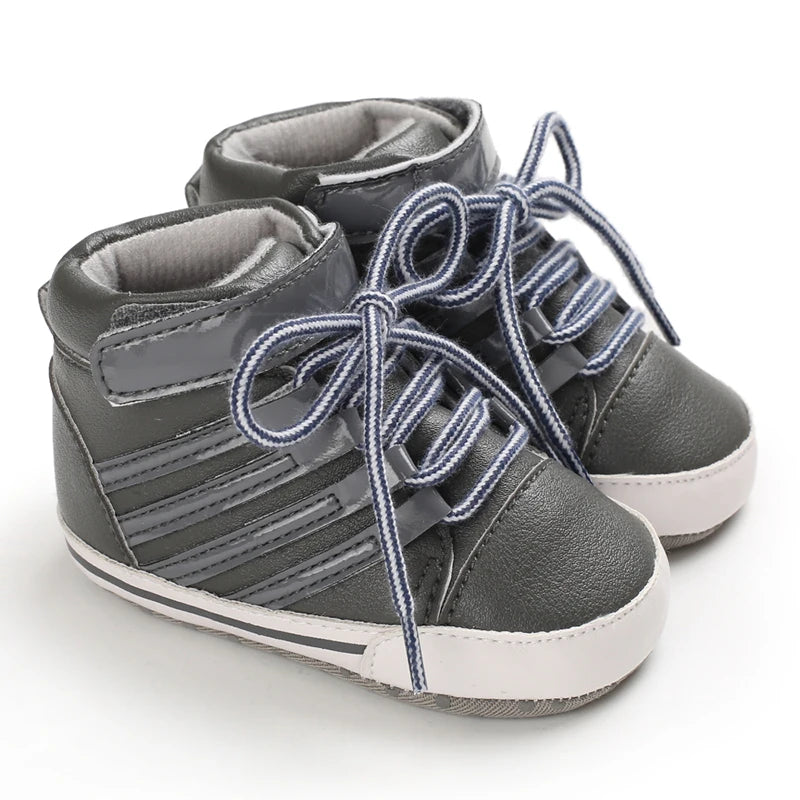 Gray high-top baby shoes with blue laces on a white background