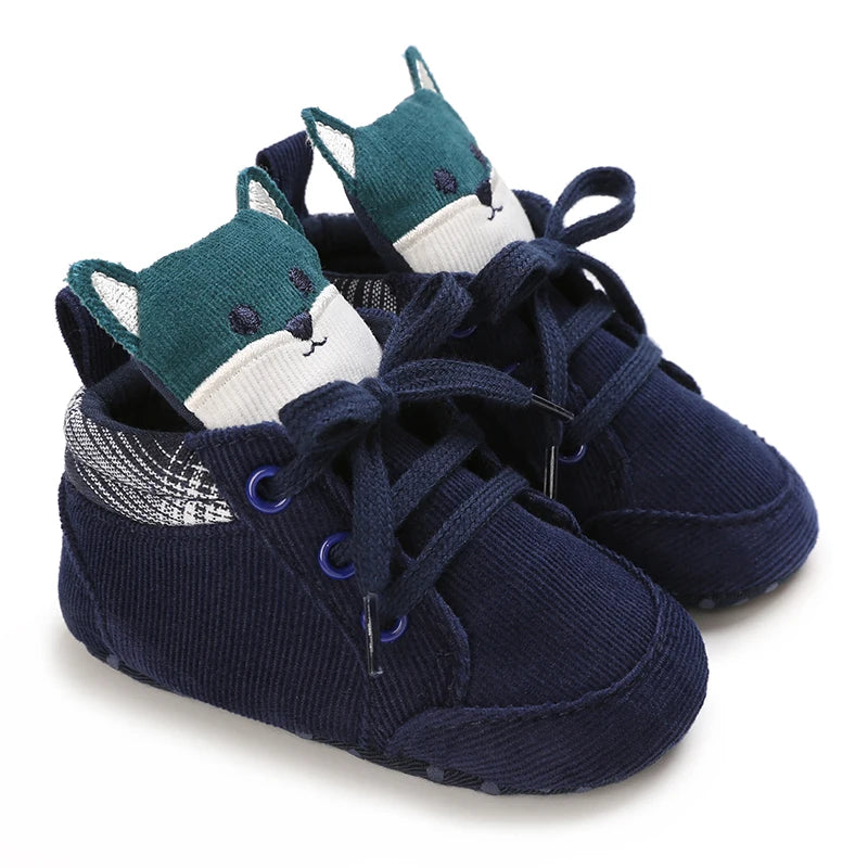 Navy blue baby shoes with fox design on a white background