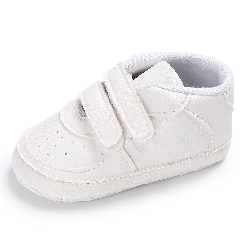 White baby shoe with velcro straps on a white background