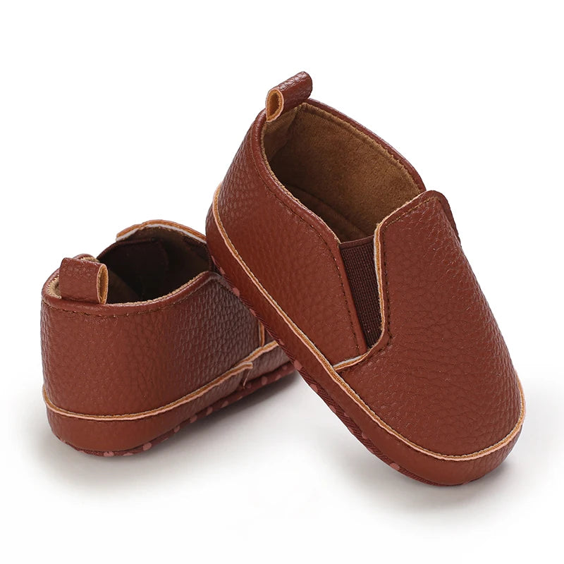 Pair of brown leather shoes on a white background