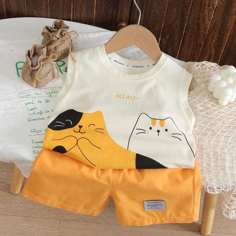 Baby bib and shorts set with cat design on a wooden hanger.
