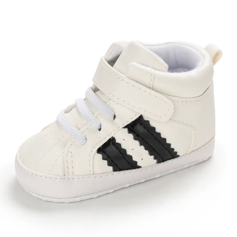 White baby shoe with black stripes on a white background
