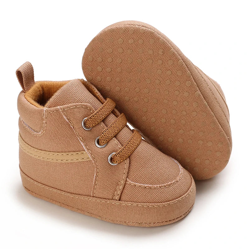 Pair of brown baby shoes on a white background