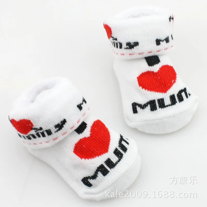 White baby socks with red hearts and black text on a white background