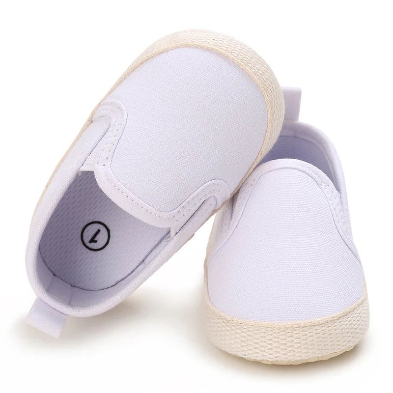 White slip-on shoes with jute sole on a white background