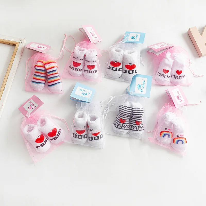 Set of baby socks with 'Mama' and 'Papa' text on a white background