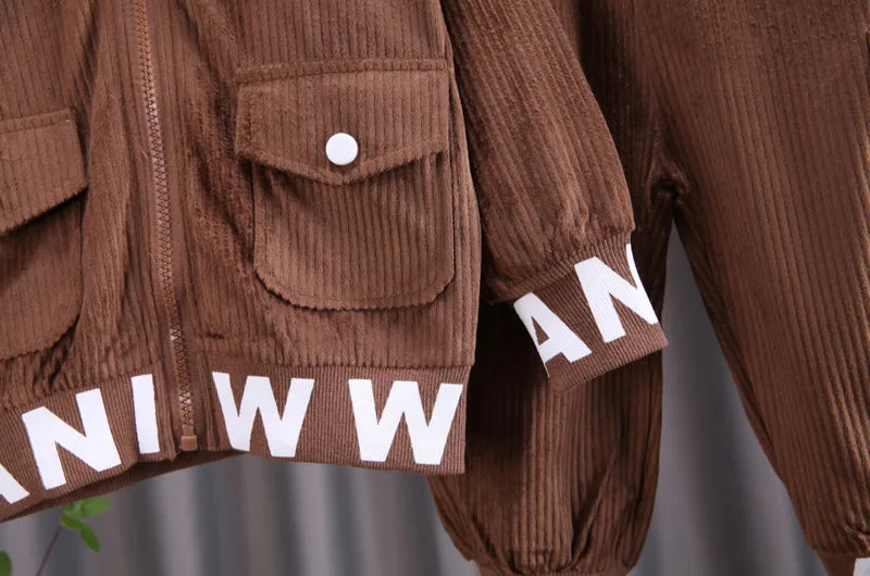 Brown corduroy jacket with white lettering on a blurred background