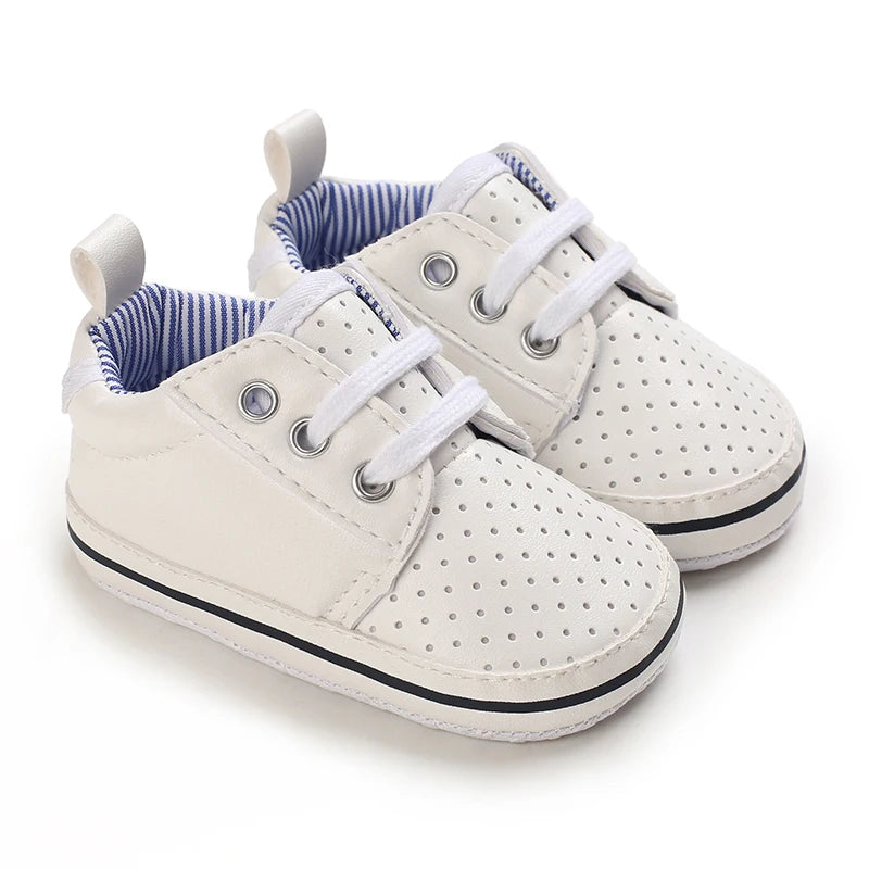 White baby sneakers with blue interior on a white background