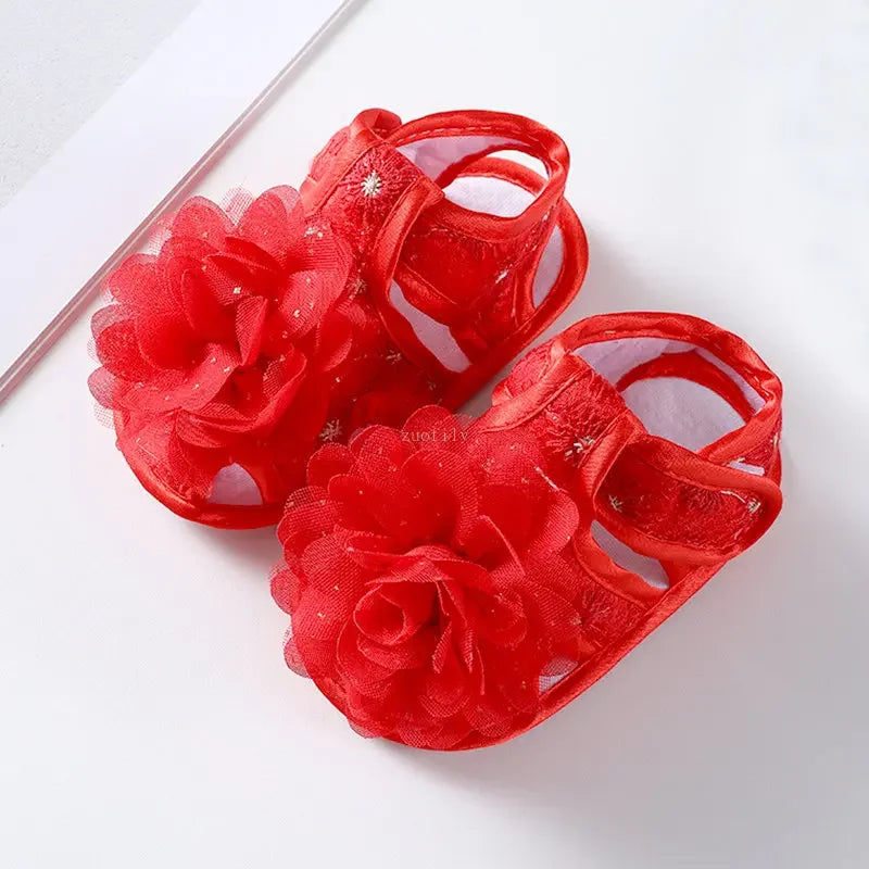 Red floral sandals on a white background
