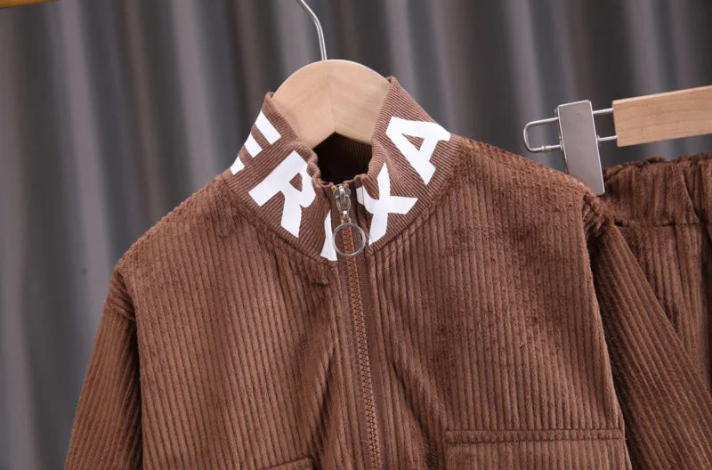 Brown corduroy jacket with 'FIRX' branding on a hanger against a gray background