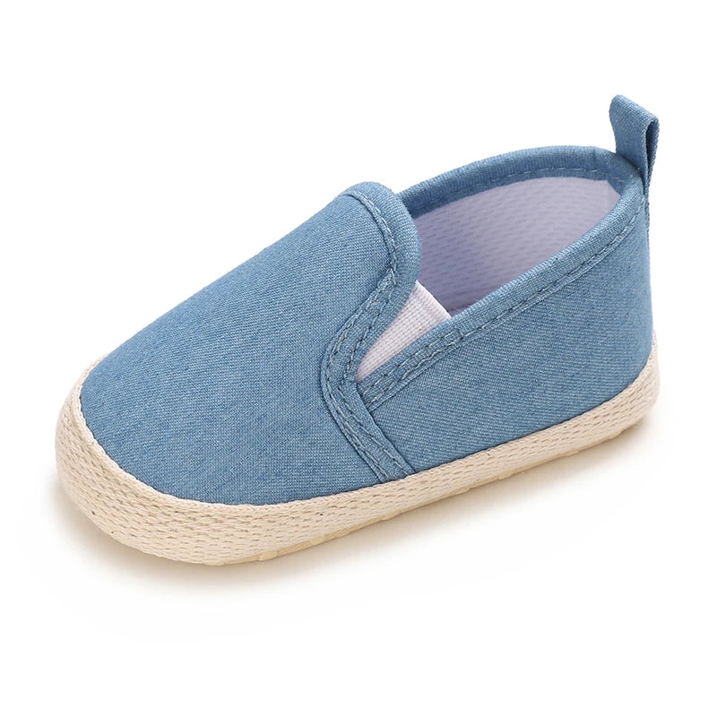 Blue baby shoe with white sole on a white background