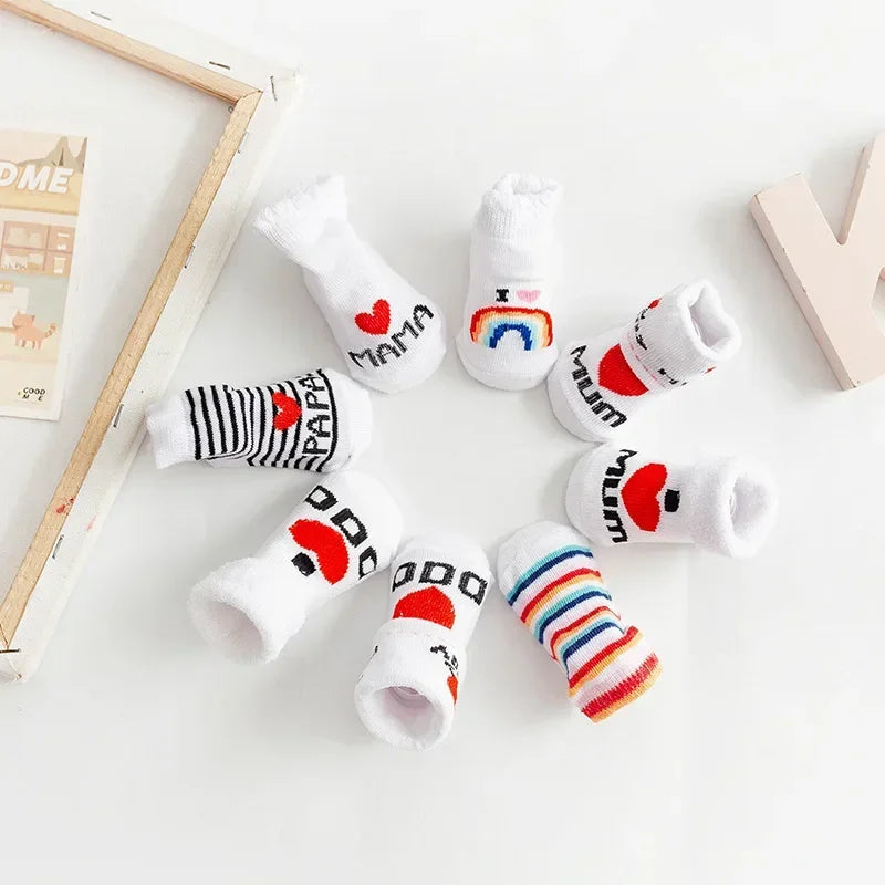 Set of baby socks with various designs on a light background